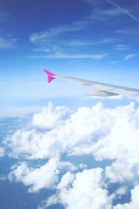 Low angle view of airplane flying against blue sky
