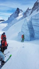 People skiing on snowy field