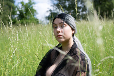 Portrait of young woman on field