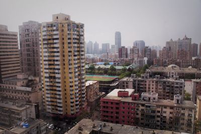 Buildings in city against clear sky