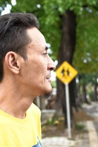 Close-up of man with yellow umbrella