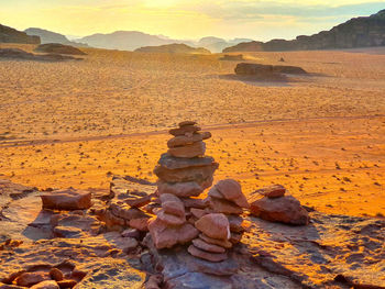 Stack of rocks on land against sky