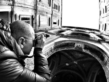 Cropped image of man photographing palazzo dello spagnolo