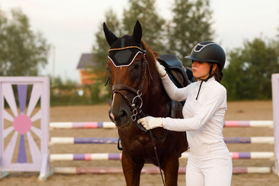 Side view of woman riding horse