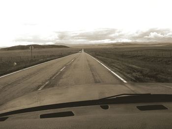 Car on landscape against sky