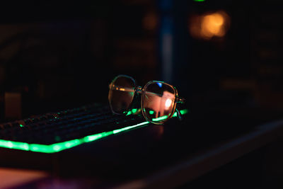 Close-up of illuminated light bulb on table