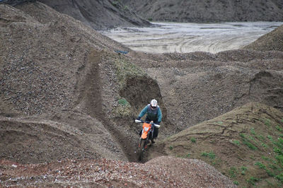 Biker riding motorcycle on mountain