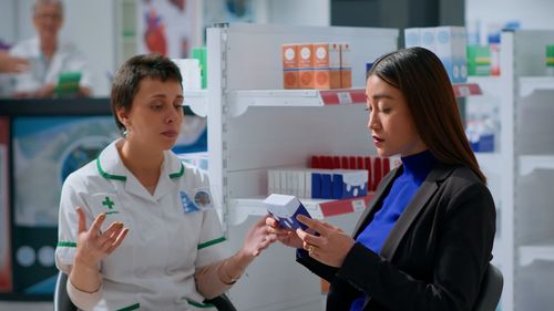 Portrait of smiling female doctor using mobile phone