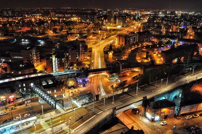 Aerial view of illuminated cityscape against sky at night