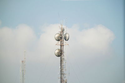 Low angle view of communications tower against sky