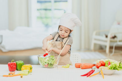 Midsection of baby girl on table at home
