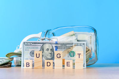 Close-up of coins on table against blue background