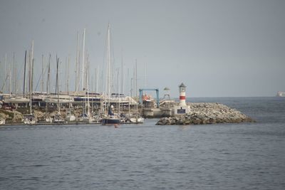 Sailboats in sea against clear sky