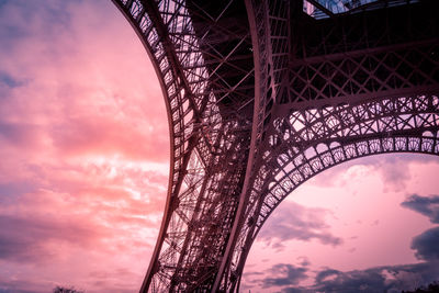 Low angle view of bridge against cloudy sky