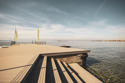 Pier over sea against sky