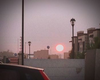 High section of buildings against clear sky at sunset