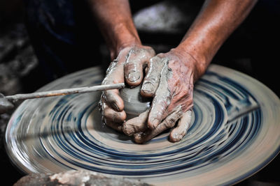 Midsection of man working in mud