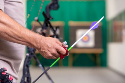 Cropped image of man holding bow