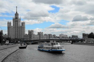 Bridge over river against cloudy sky
