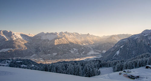 Scenic view of snowcapped mountains against clear sky