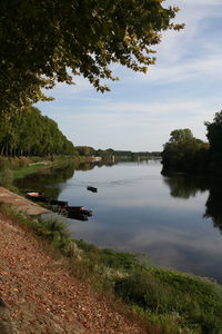 Scenic view of calm lake against sky