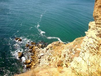 High angle view of cliff by sea