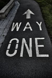 High angle view of arrow sign on road in city