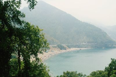 Scenic view of sea and mountains against sky