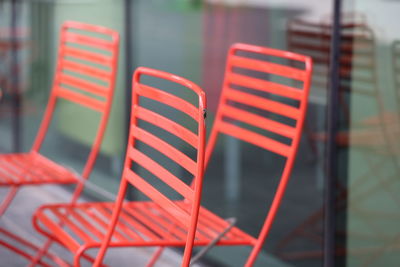 Close-up of red chairs against blurred background