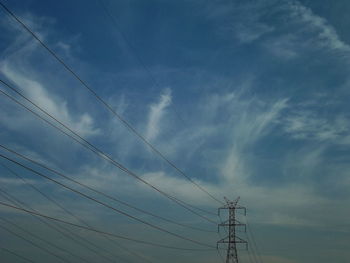 Low angle view of cables against sky