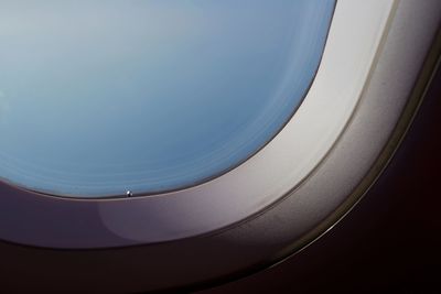 Close-up of airplane wing against blue sky