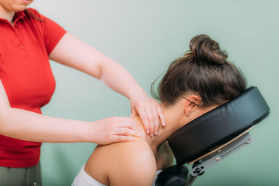 Chair massage. therapist massaging womans neck, stress and tension relief