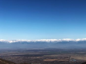 Scenic view of landscape against blue sky