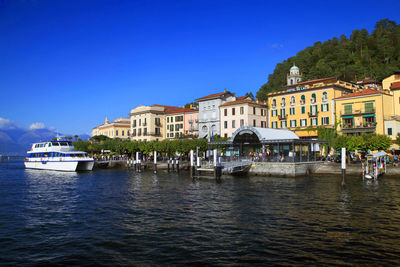 Boat in river against built structures