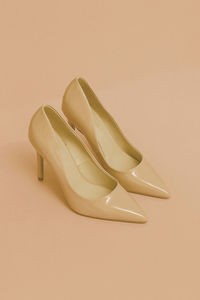 High angle view of shoes against pink background