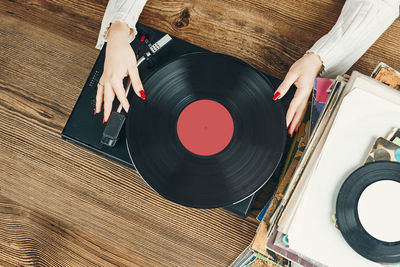 Listening to music from vinyl record. analog equipment. retro music. vintage style. fashionable