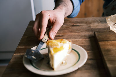 Midsection of person holding ice cream in plate