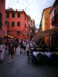 People walking on street amidst buildings in city