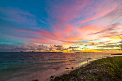 Scenic view of beach against sky during sunset