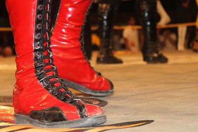 Low section of people in red shoes