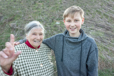 Portrait of smiling grandmother with grandson outdoors