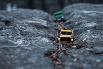 Close-up of toy car on rock