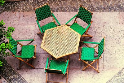 High angle view of empty chair on footpath