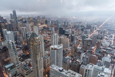 High angle view of modern buildings in city against sky