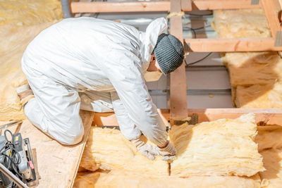 Side view of man working at construction site