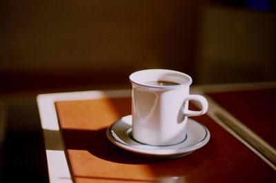 Close-up of coffee cup on table