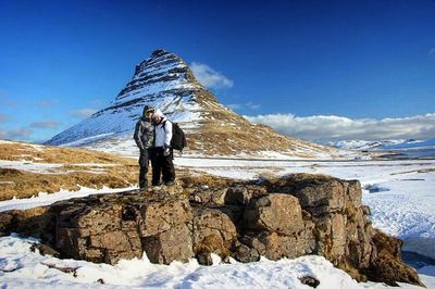 Tourist walking on snow covered landscape