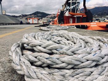 Close-up of rope tied to moored at harbor