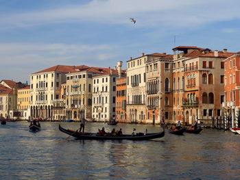 Boats in venice canal along buildings