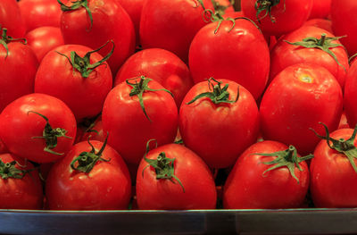 Group of red tomatoes in a basket for sale